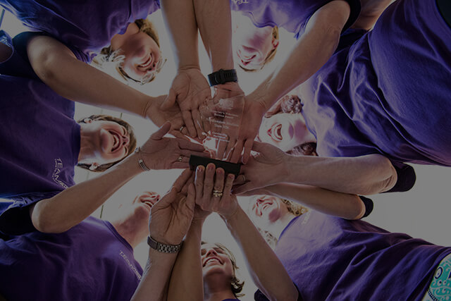 Employees putting hands together