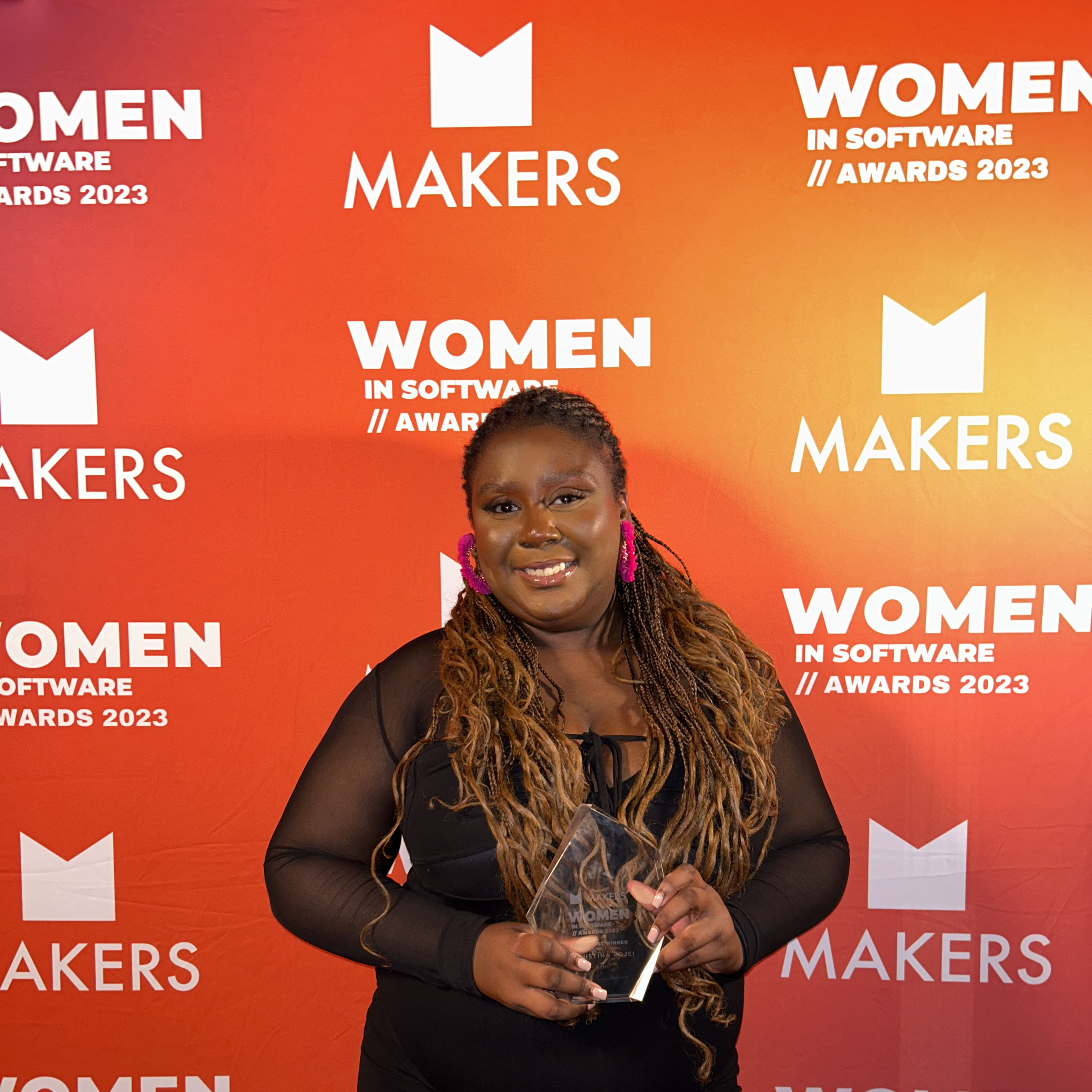 Winner holding award at Women in Software Awards 2023.